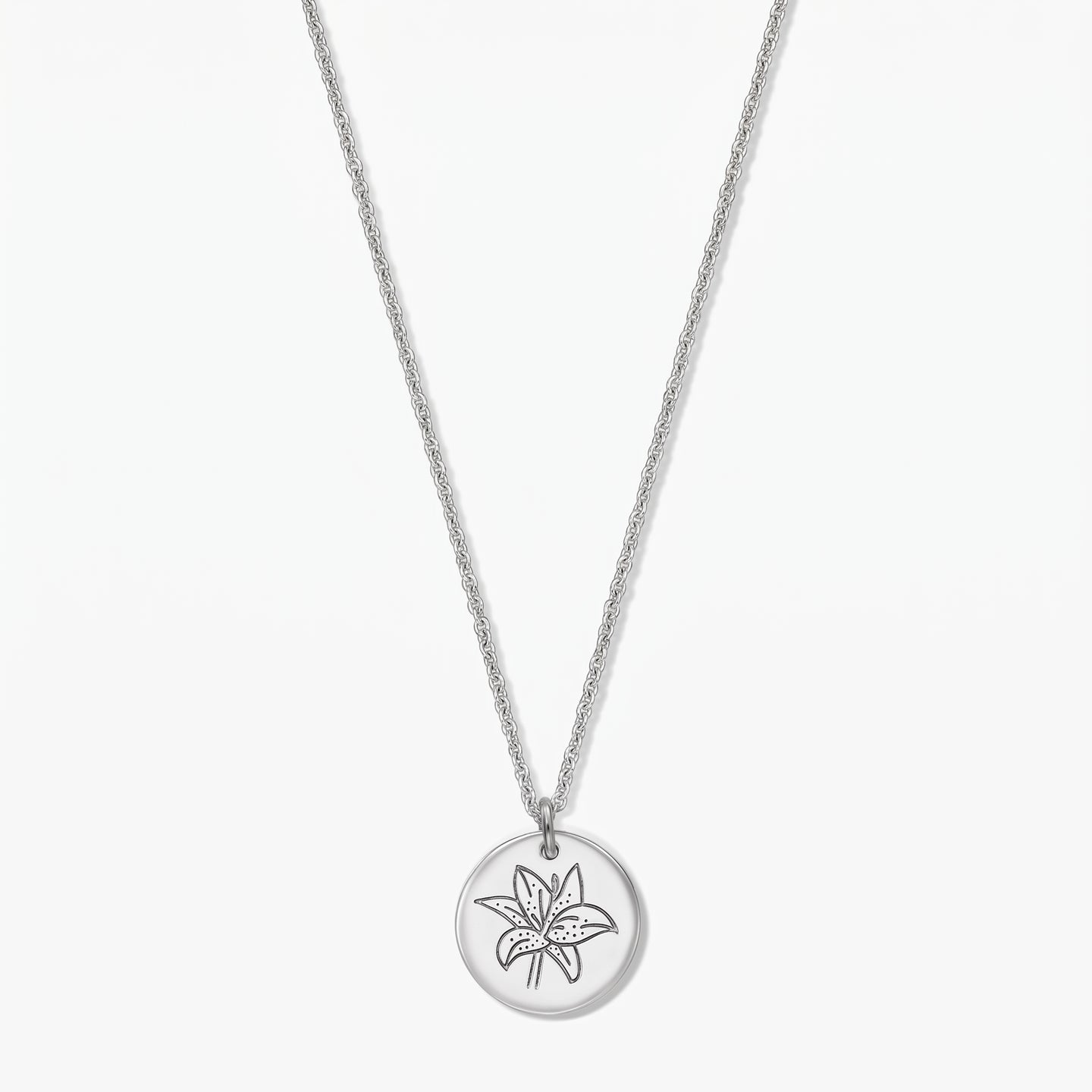 Sterling silver birth flower necklace featuring a round disc pendant engraved with a lily (May), shown on a white background.