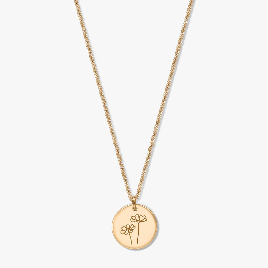 Gold-plated silver necklace featuring a round disc pendant engraved with two cosmos flowers, set against a white background.