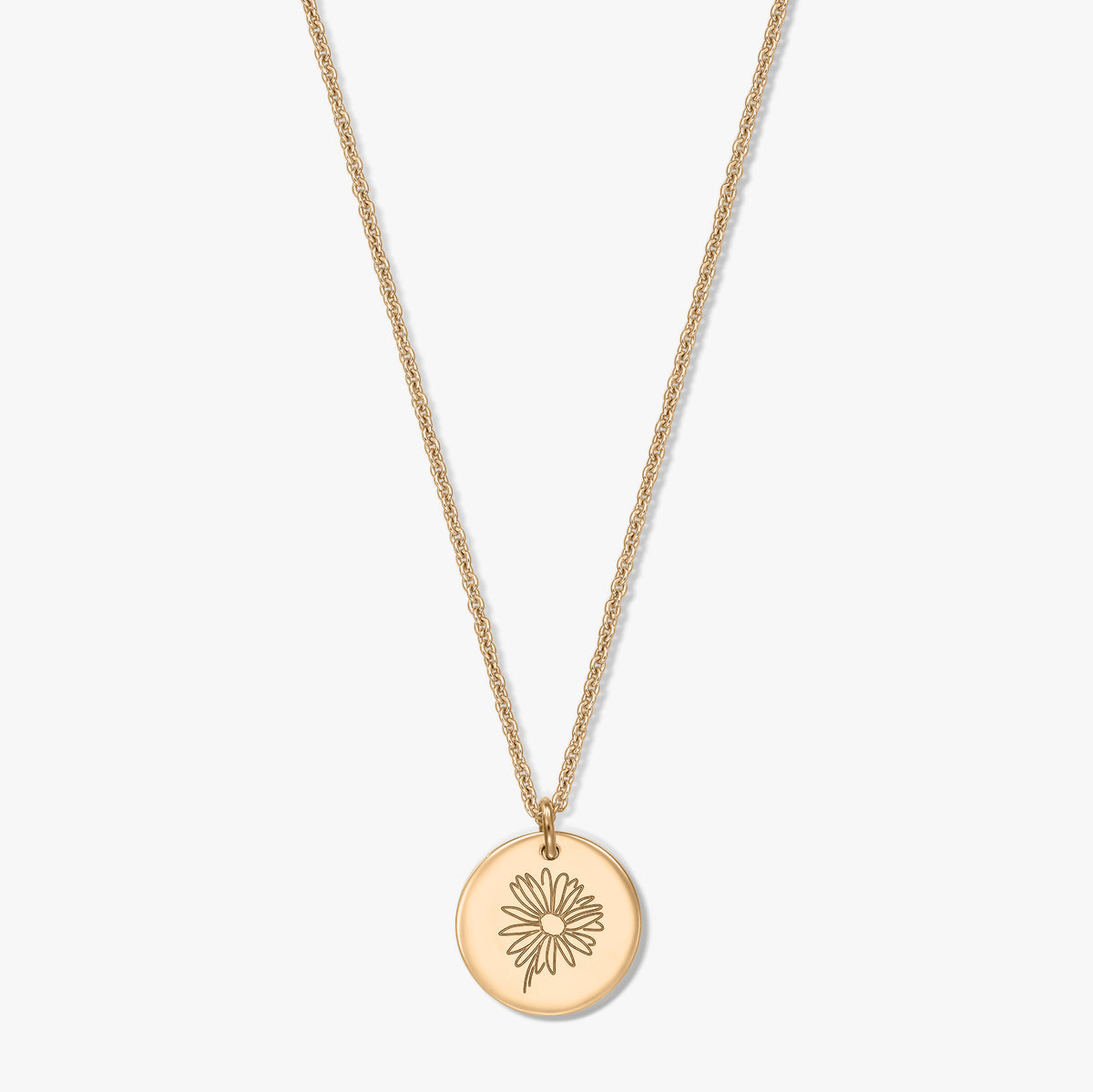 Elegant gold‑plated silver necklace with a round disc pendant engraved with a daisy, centered on a white background.