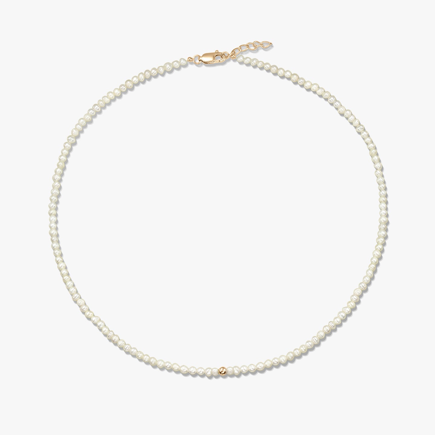 Square product photo of a delicate natural pearl beaded necklace featuring a small 14K yellow gold accent bead and a yellow-gold lobster clasp with a short extender, on a white background.