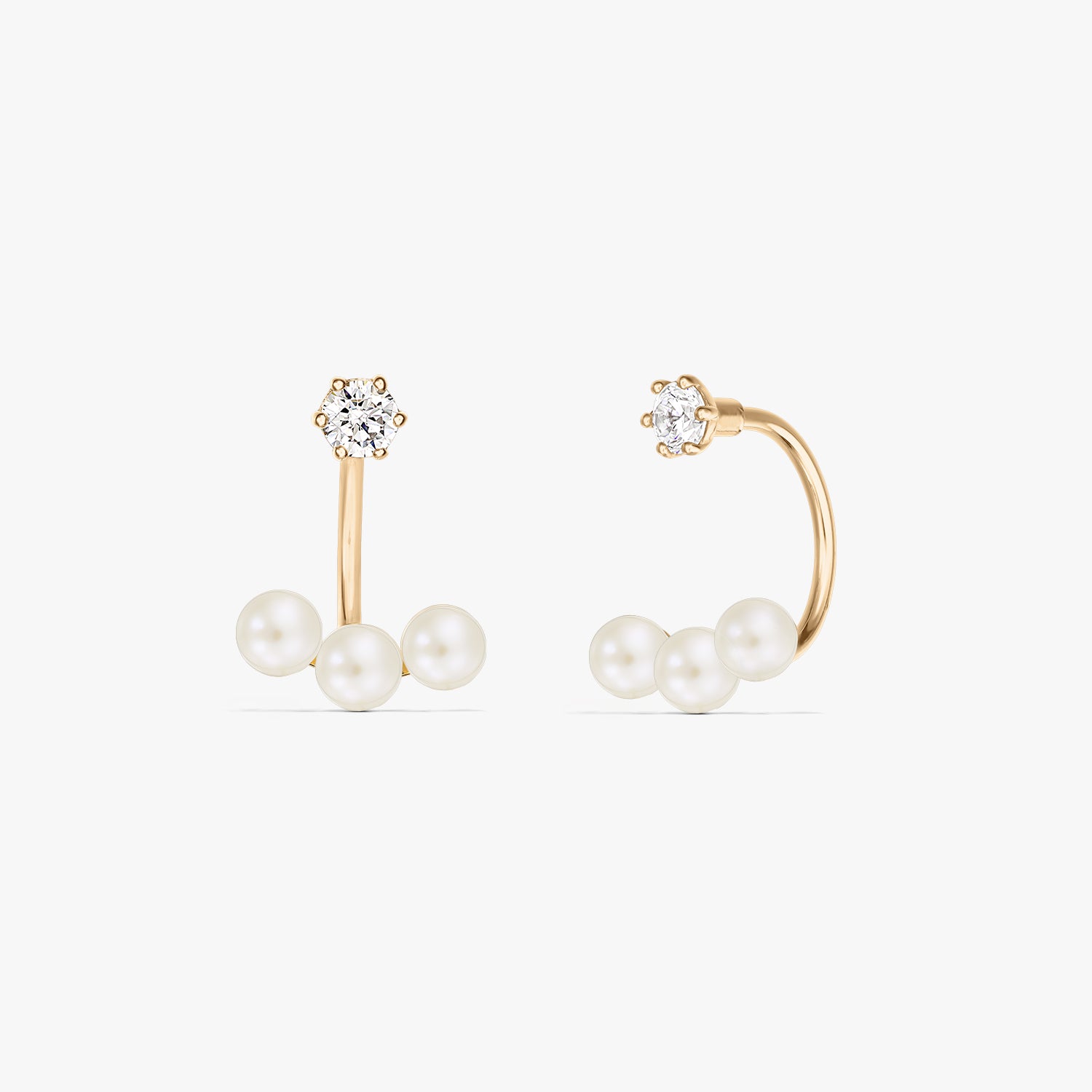 Square product photo of a pair of 14K yellow gold ear jacket earrings featuring three natural pearls beneath a small round stud on a pure white background.
