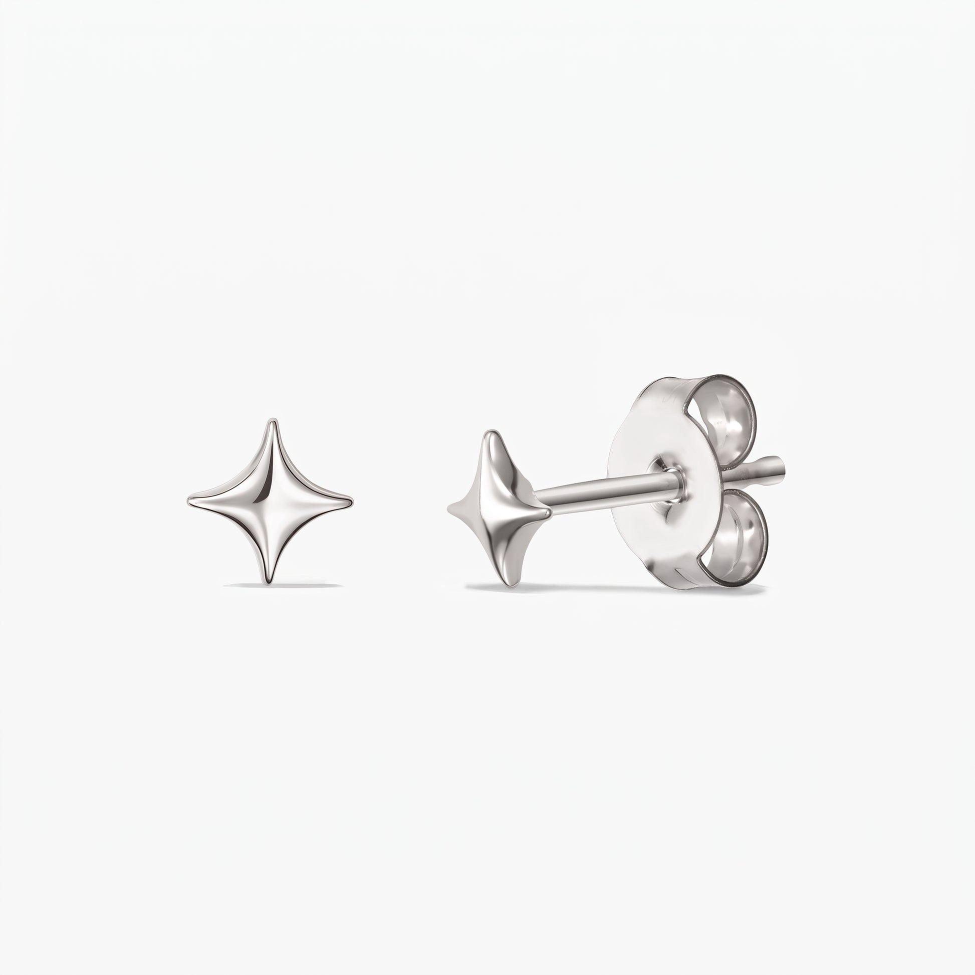 Cosmic Star Silver Earrings — a pair of 925 sterling silver star-shaped stud earrings shown front and side with butterfly backs on a white background.