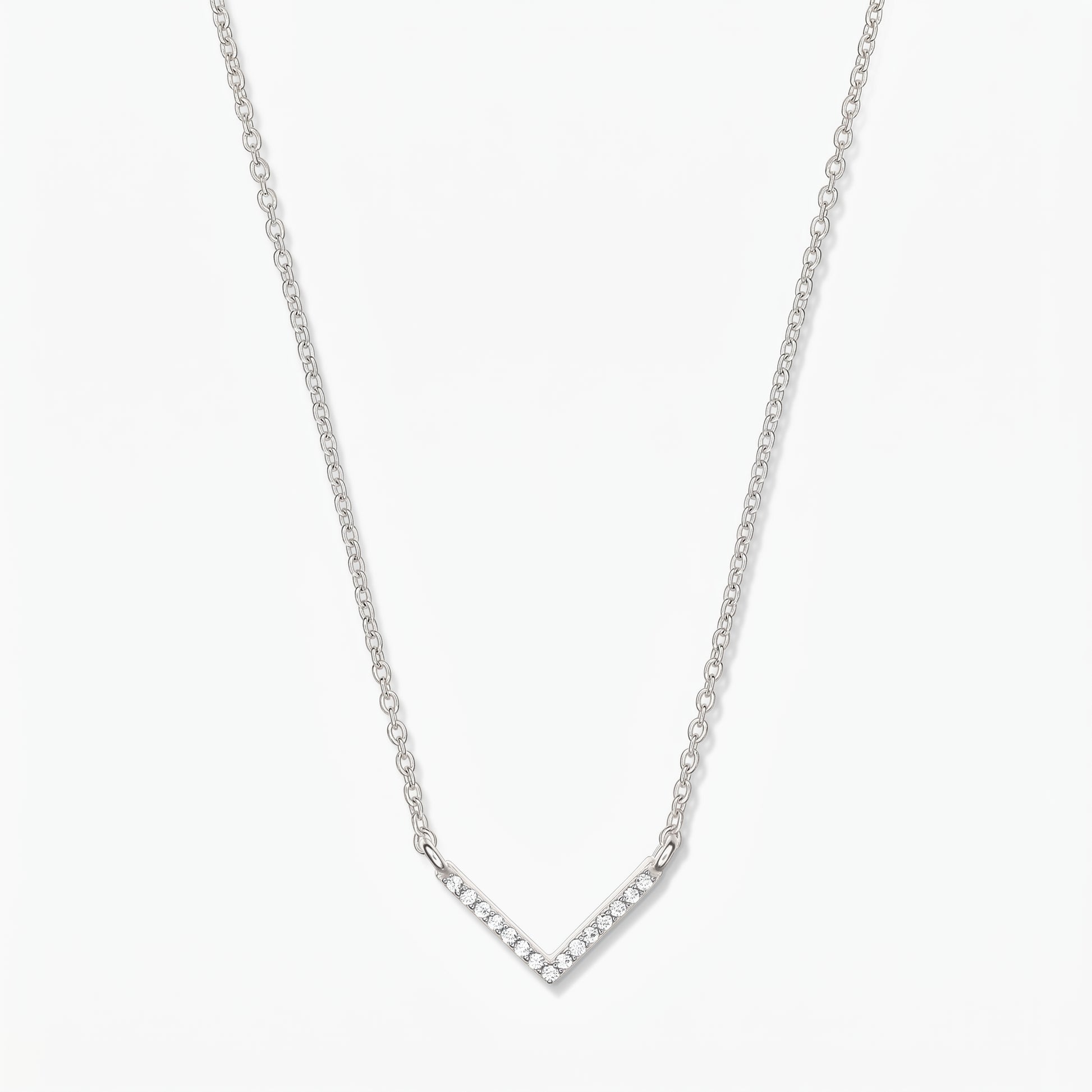 Silver V-shaped zirconia necklace with a delicate chain and pavé chevron pendant on a white background.