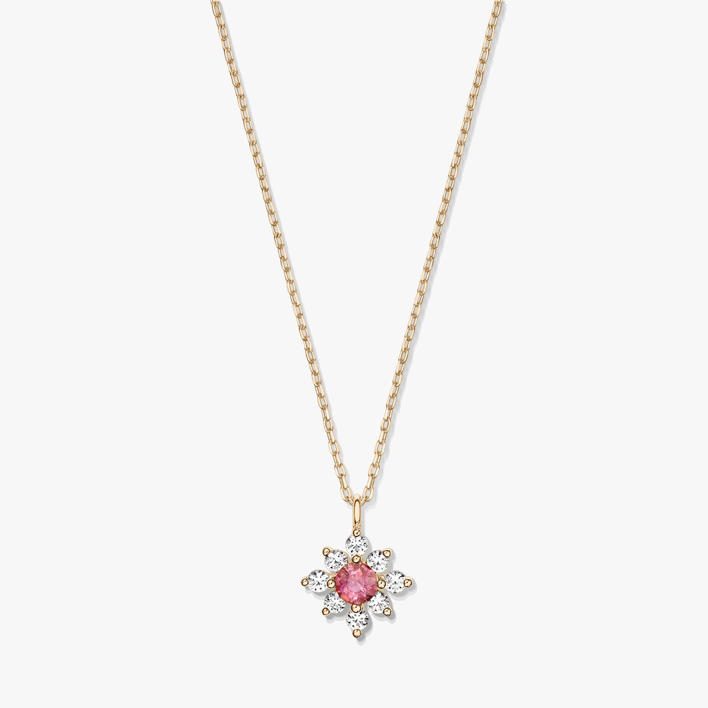 Elegant 14K gold necklace with a floral pendant featuring a pink tourmaline center haloed by white sapphires on a white background.