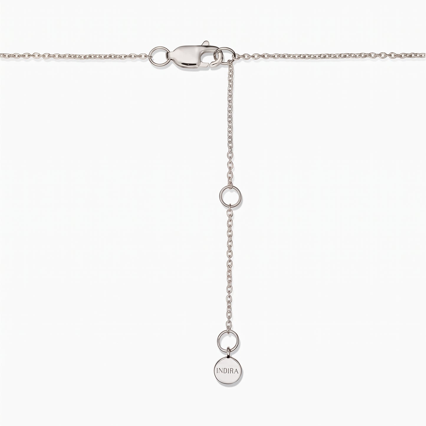 Close-up of a sterling silver necklace clasp with an adjustable extender chain and a small round Indira tag on a white background.