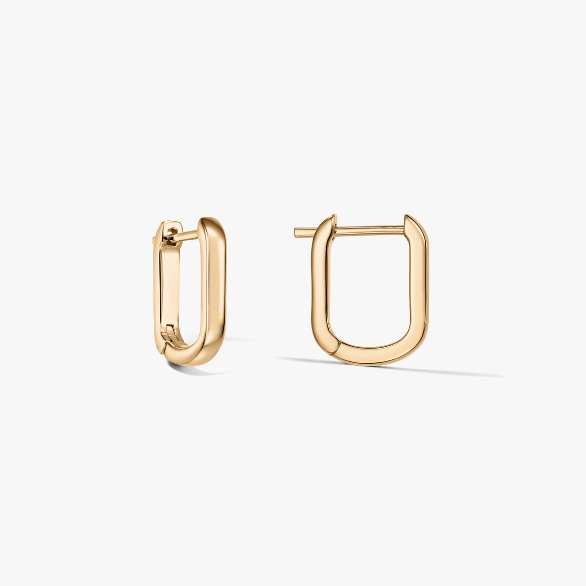 Pair of U-shaped gold-plated sterling silver hoop earrings on a white background, one earring open and one closed.