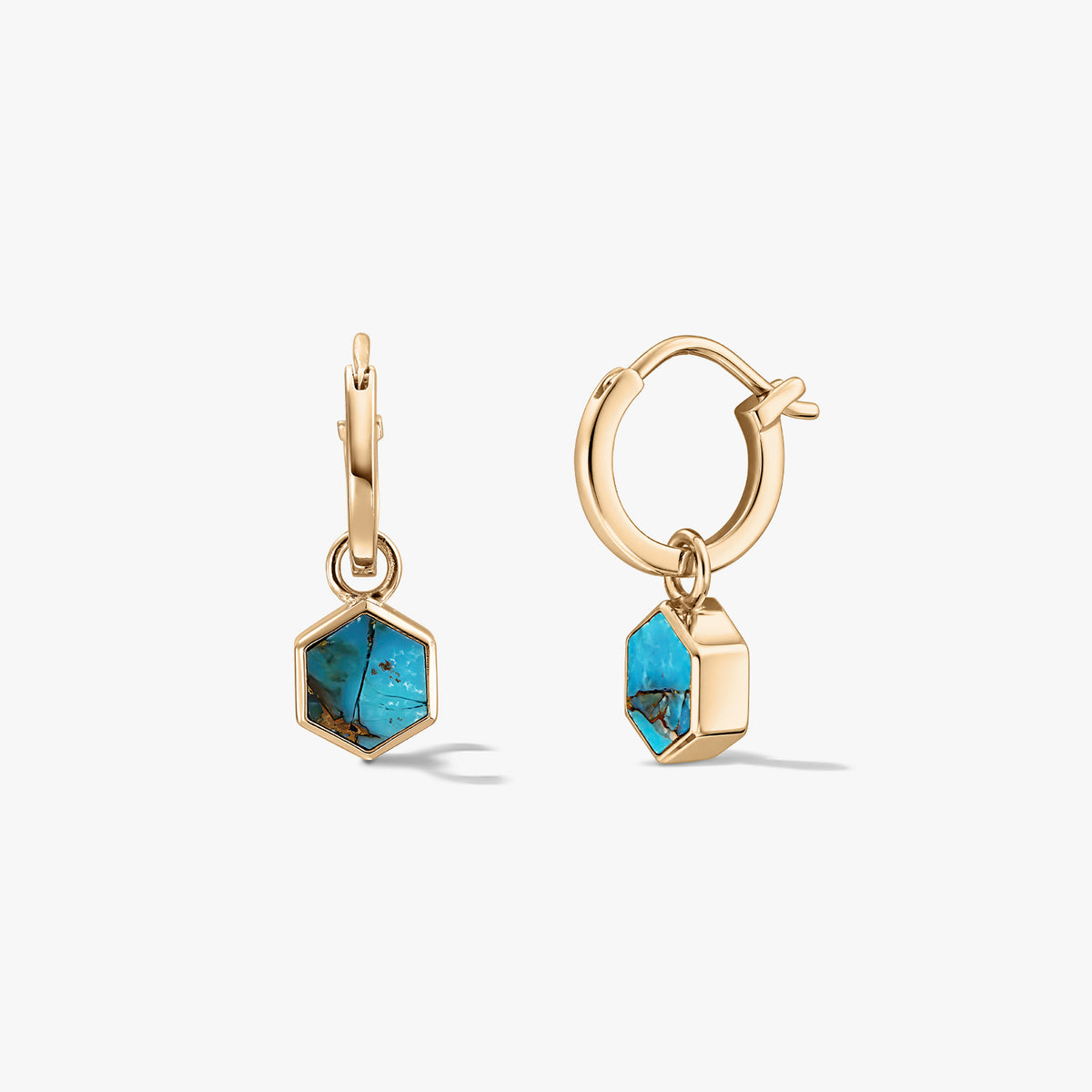 Pair of small gold-tone huggie hoop earrings with hexagon turquoise blue-copper stone charms on a white background.