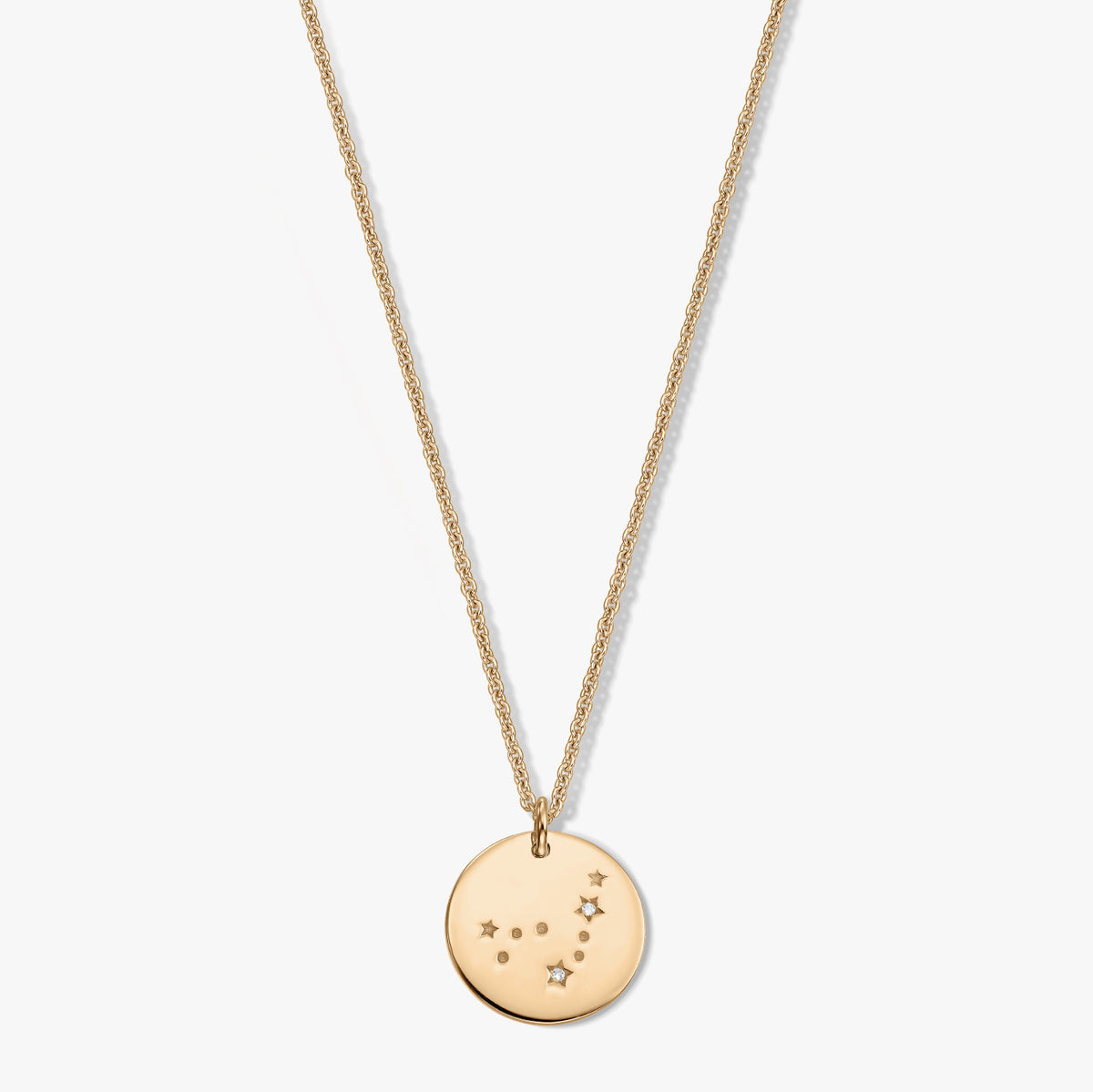 Gold-tone round Capricorn zodiac pendant necklace featuring small white sapphire accents on a delicate chain, displayed on a white background.