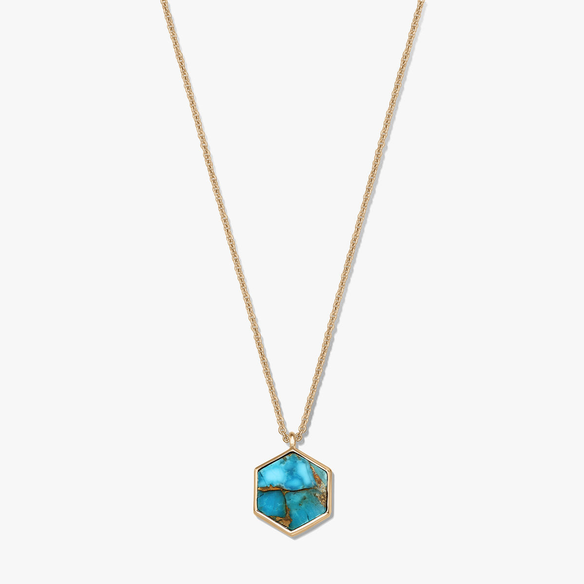 Elegant gold-plated sterling silver necklace with a hexagonal turquoise-blue copper pendant on a white background.
