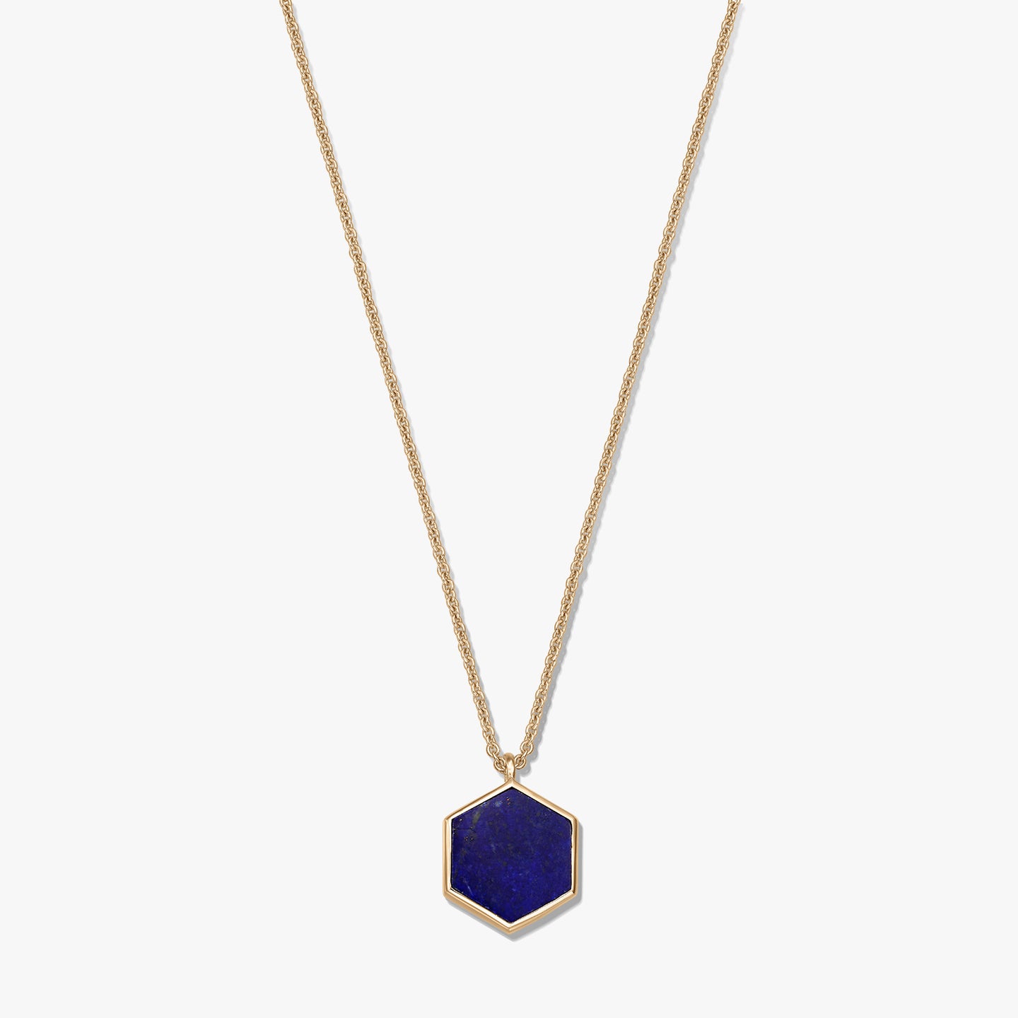Gold-plated sterling silver necklace featuring a hexagonal lapis lazuli pendant on a white background.