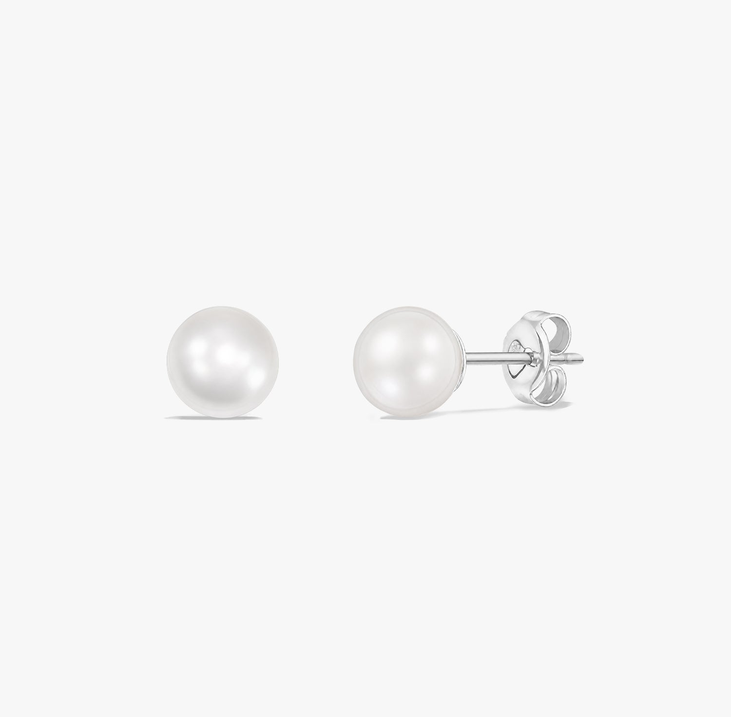 Timeless pearl stud earrings featuring natural white pearls set in 925 sterling silver on a white background.