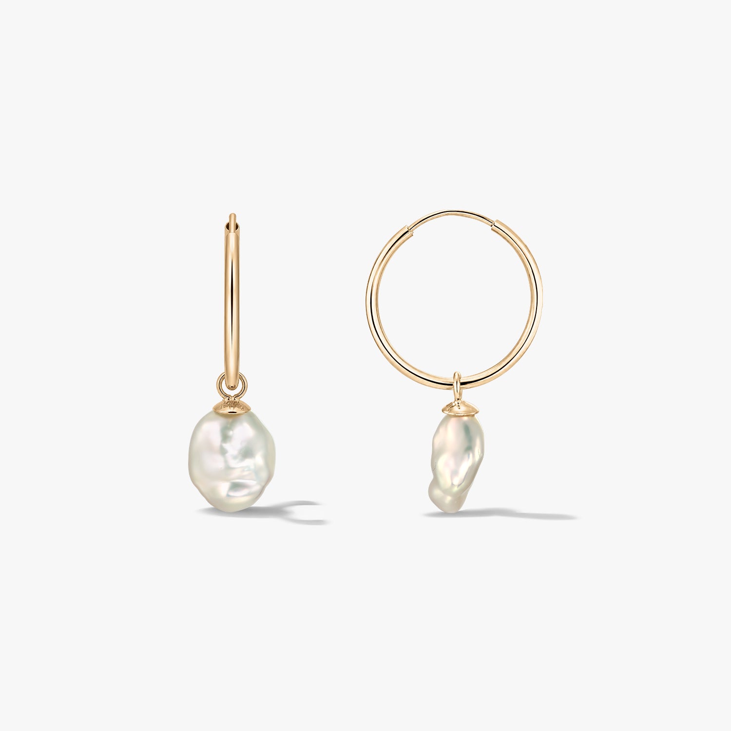 Pair of 14K yellow-gold hoop earrings with irregular natural pearl drops on a white background, shown in front and side views.