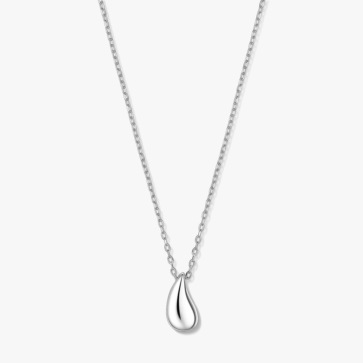Elegant silver teardrop pendant necklace on a fine chain, photographed on a white background.