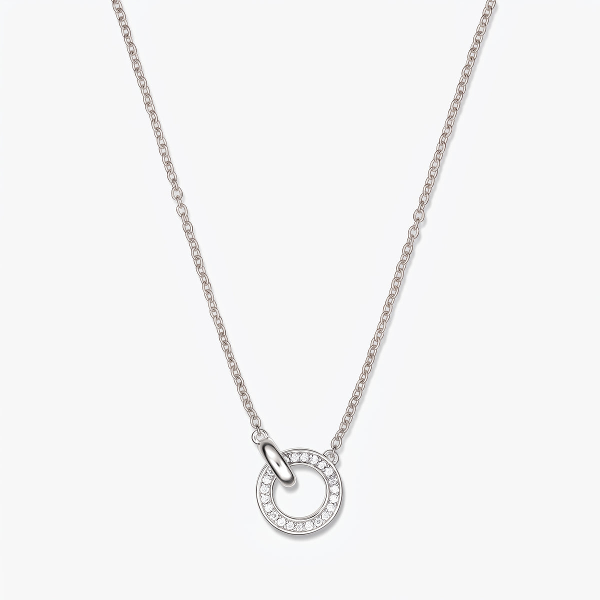 Elegant linked silver necklace featuring a double-circle pendant accented with small clear stones on a fine silver chain, photographed on a white background.