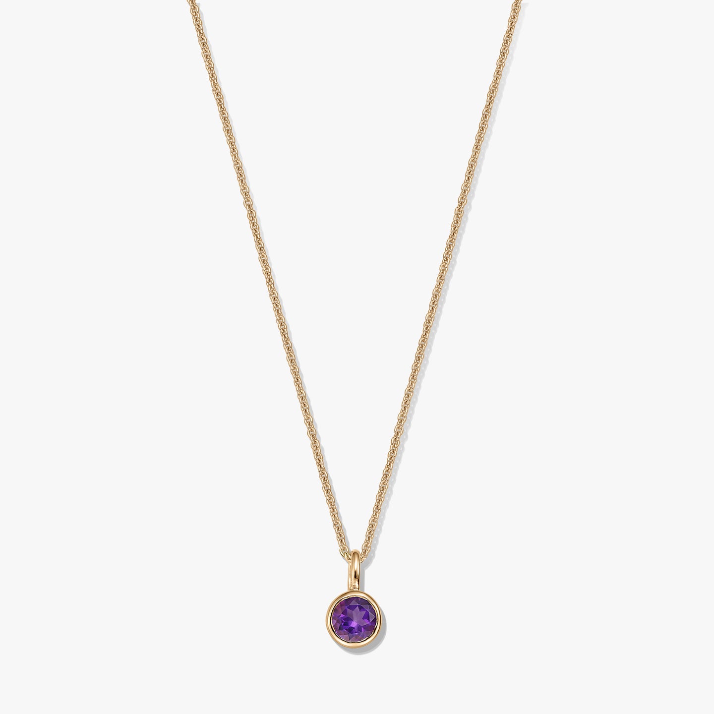 Gold-plated sterling silver necklace with a small round amethyst birthstone pendant on a white background.