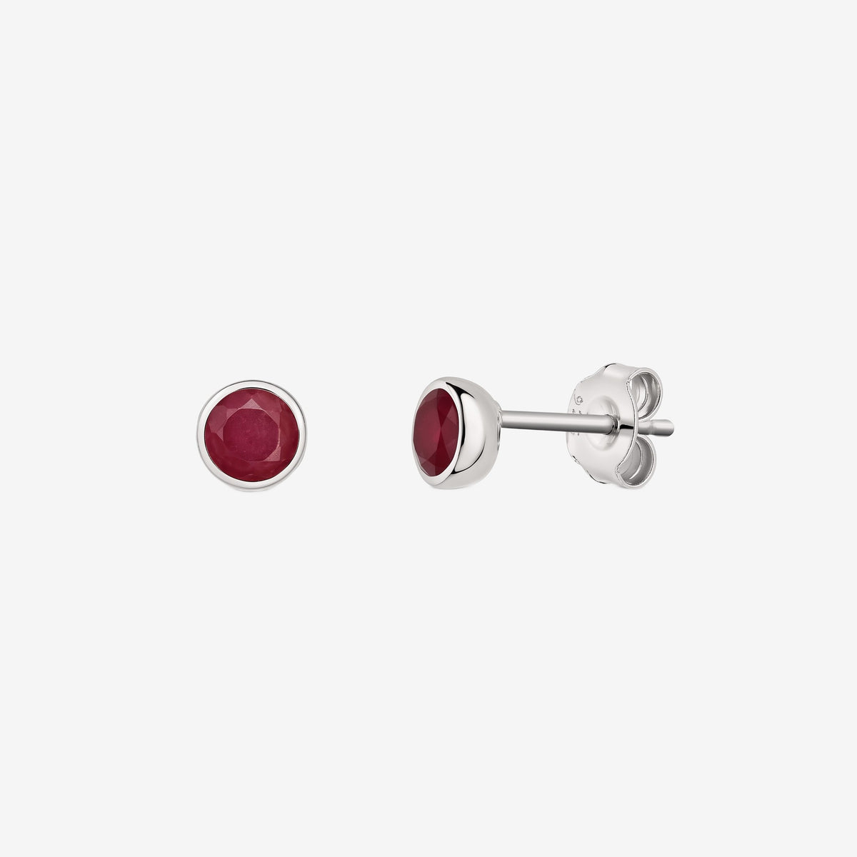 Pair of silver bezel-set ruby stud earrings displayed on a white background, shown from front and side views.