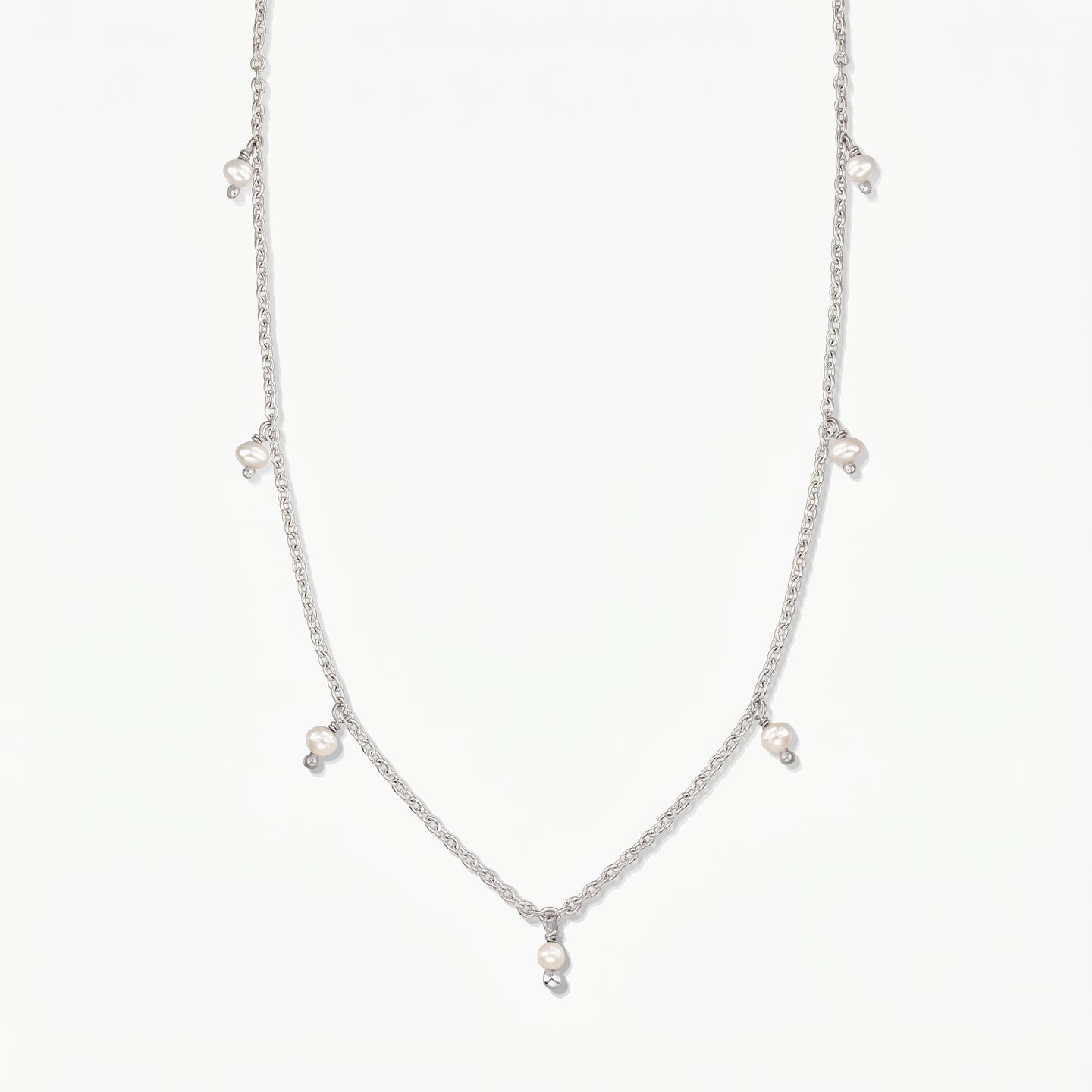 Indira Margot silver necklace with small natural pearl drops, photographed on a clean white background.