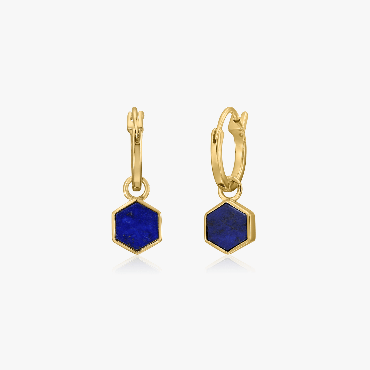 Pair of gold-plated silver earrings featuring hexagon-shaped blue lapis lazuli stones on a white background.