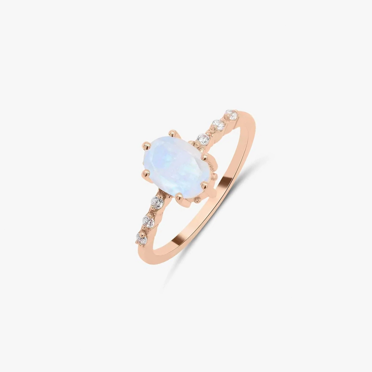 Rose gold ring featuring moonstone and zircon details on a solid white background.