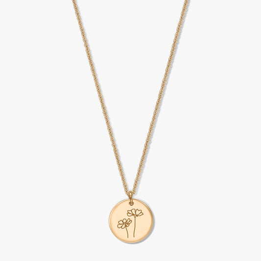 Gold-plated silver necklace featuring a round disc pendant engraved with two cosmos flowers, set against a white background.