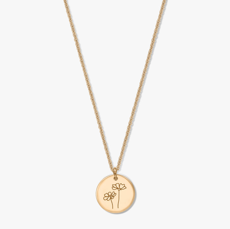 Gold-plated silver necklace featuring a round disc pendant engraved with two cosmos flowers, set against a white background.
