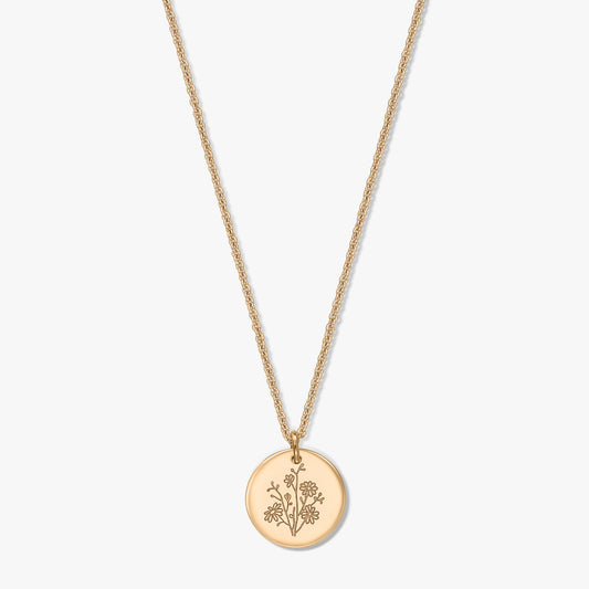 Gold-plated silver necklace featuring a delicate rope chain and a round coin pendant engraved with an aster birth flower, isolated on a white background.