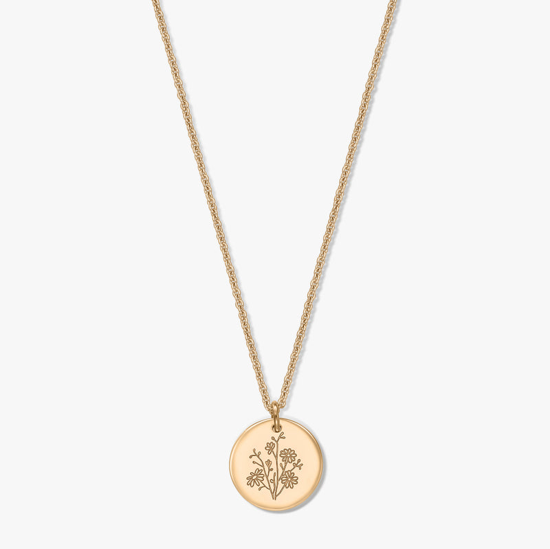 Gold-plated silver necklace featuring a delicate rope chain and a round coin pendant engraved with an aster birth flower, isolated on a white background.