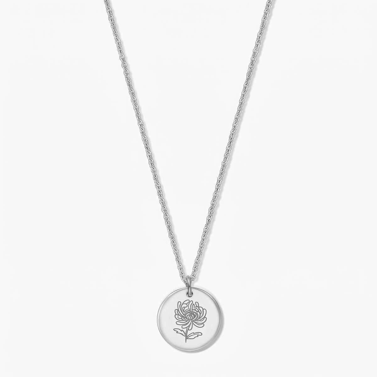 Sterling silver birth flower necklace featuring a round disc pendant engraved with a chrysanthemum on a fine chain, photographed on a white background.