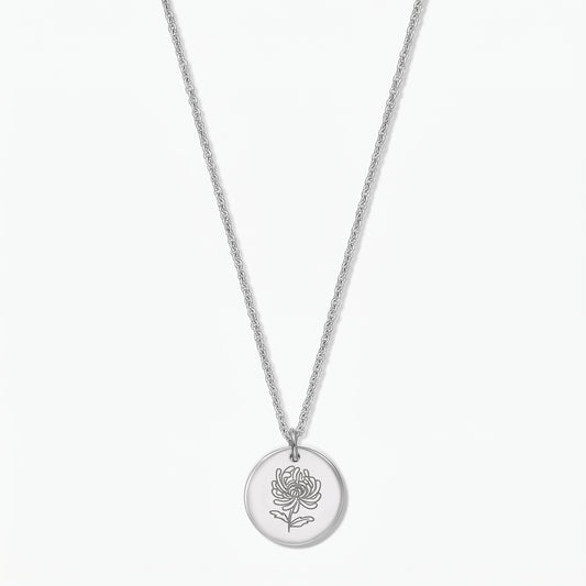 Sterling silver birth flower necklace featuring a round disc pendant engraved with a chrysanthemum on a fine chain, photographed on a white background.