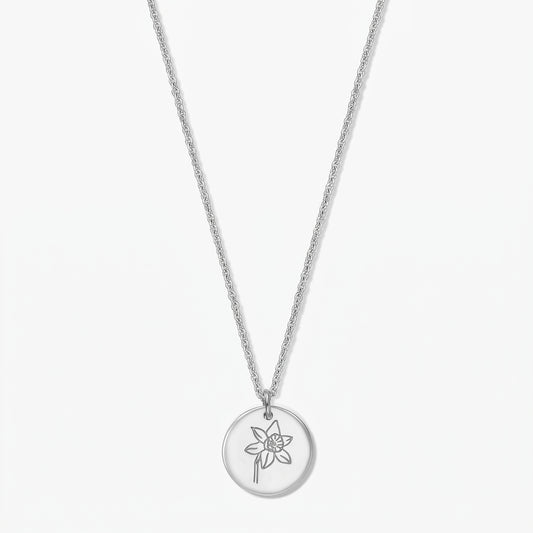 Sterling silver necklace featuring a round pendant engraved with a daffodil—the March birth flower—on a white background.