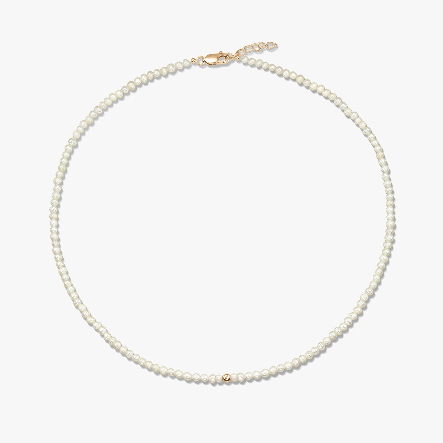 Square product photo of a delicate natural pearl beaded necklace featuring a small 14K yellow gold accent bead and a yellow-gold lobster clasp with a short extender, on a white background.