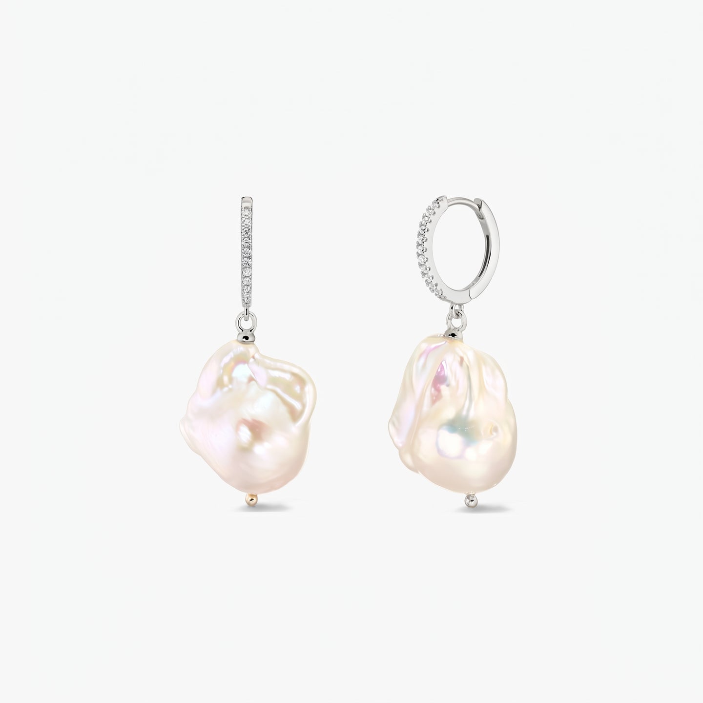 Elegant rhodium‑plated 925 silver hoop earrings with pavé zirconia and large organic baroque pearls on a white background.