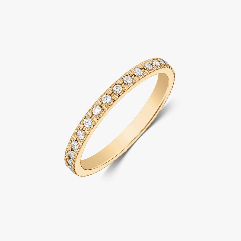 Elegant 14K yellow gold zirconia tennis wedding band with round white stones on a white background.