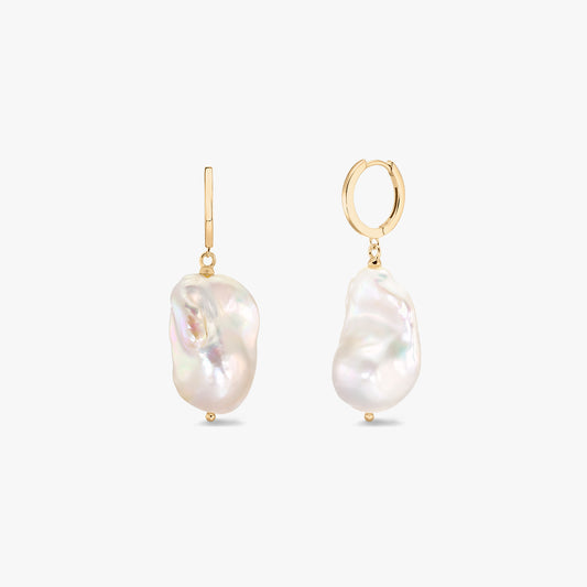 Elegant gold-plated hoop earrings with organic baroque white pearls on a white background.