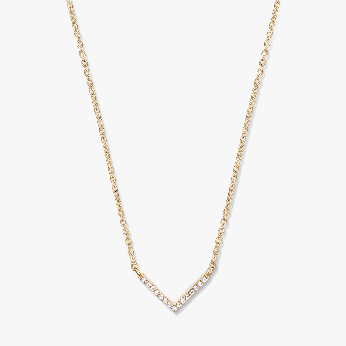 Golden V-shaped zirconia pendant necklace on a delicate chain, photographed on a white background.