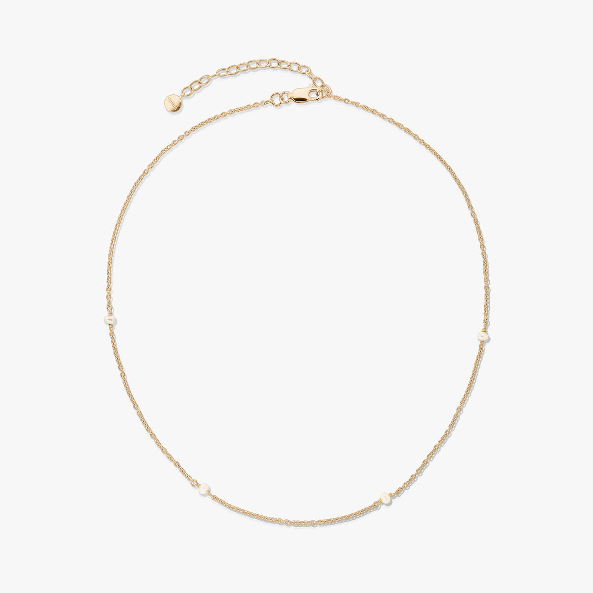 Delicate gold-plated 925 silver necklace with tiny natural pearls and an adjustable extender with a lobster clasp on a white background.