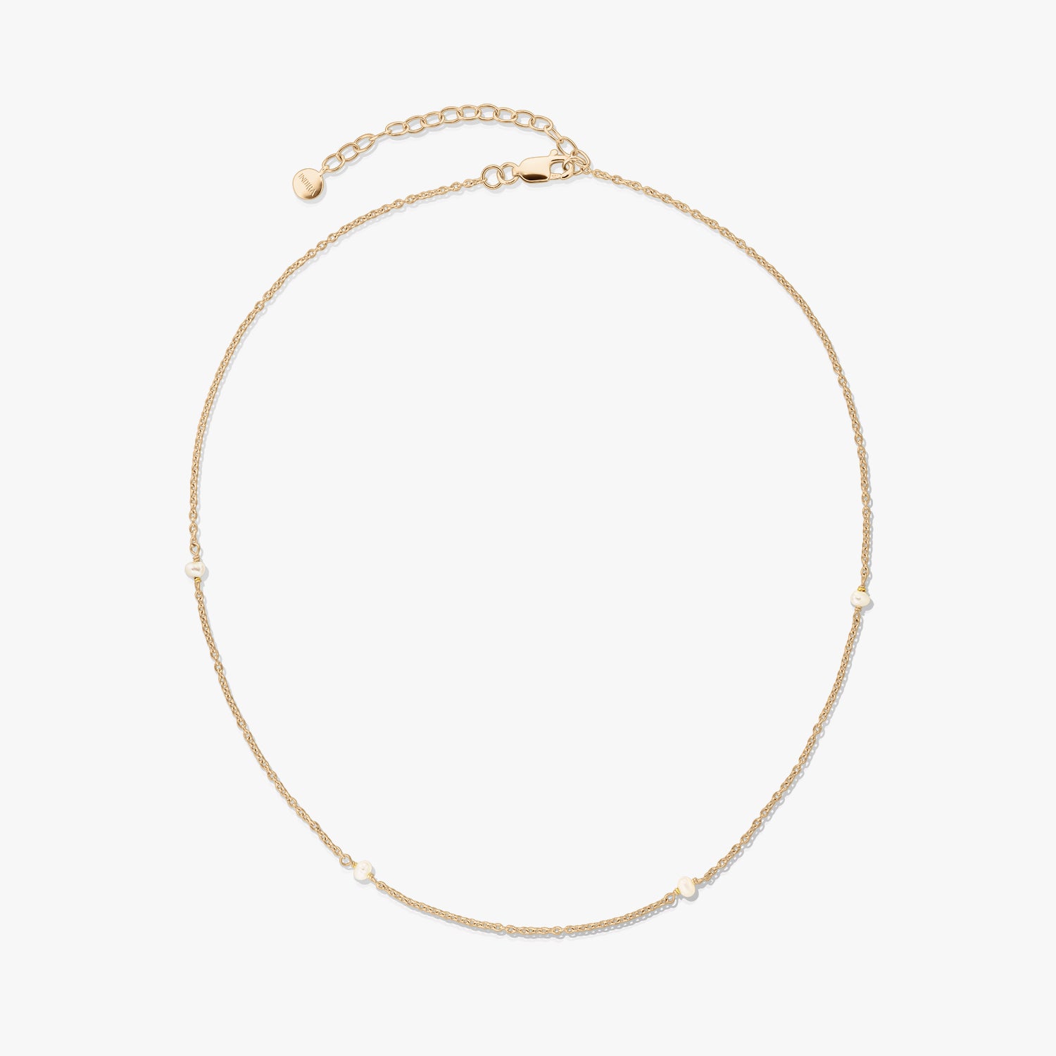 Delicate gold-plated 925 silver necklace with tiny natural pearls and an adjustable extender with a lobster clasp on a white background.