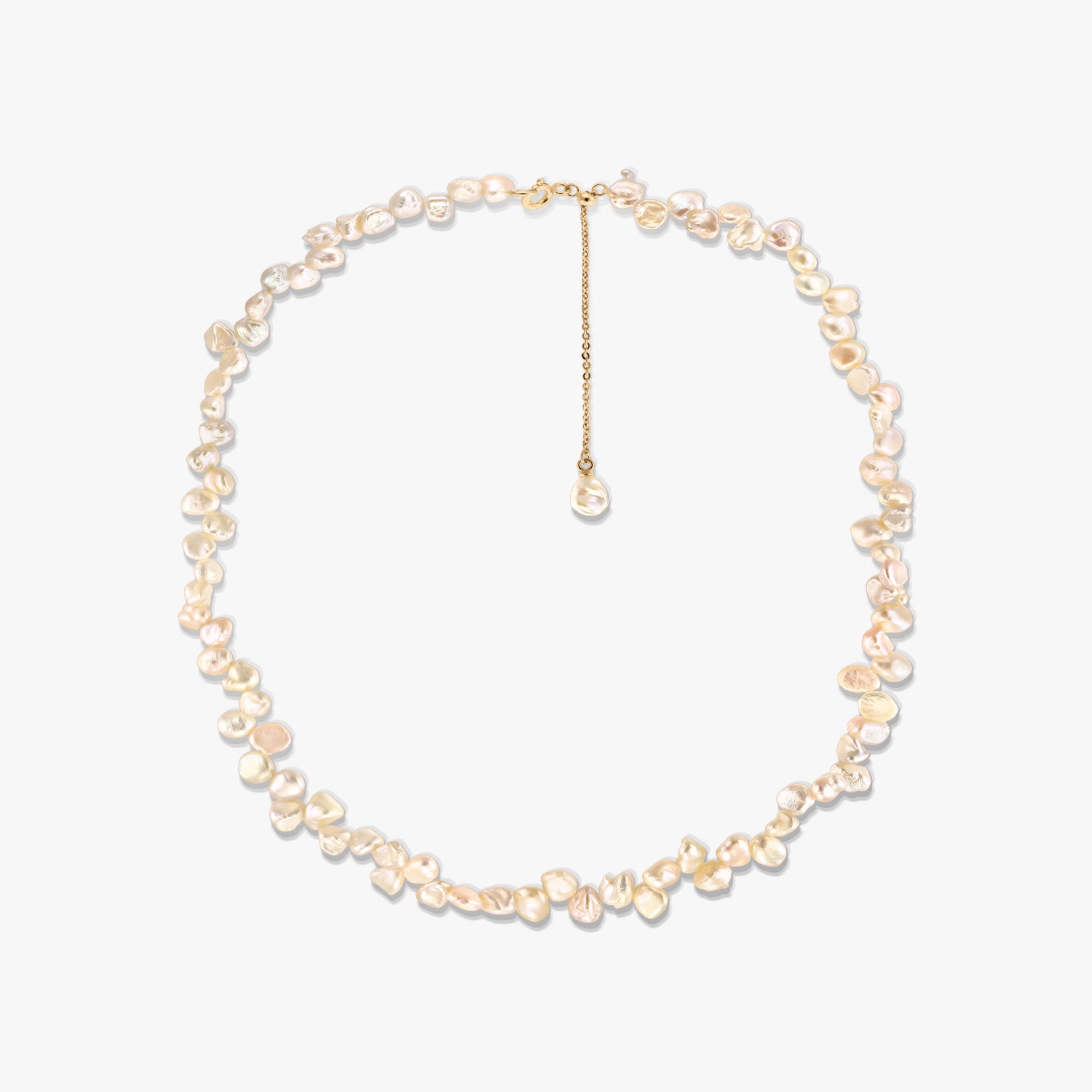 Gold-plated silver necklace featuring irregular pink keshi freshwater pearls and an adjustable chain extender, photographed on a white background.