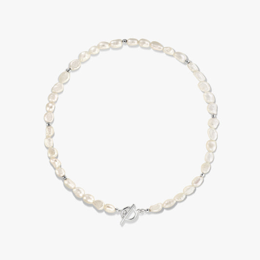 Square studio photo of a sterling silver necklace with natural freshwater pearls, small silver spacer beads, and a toggle clasp on a white background.