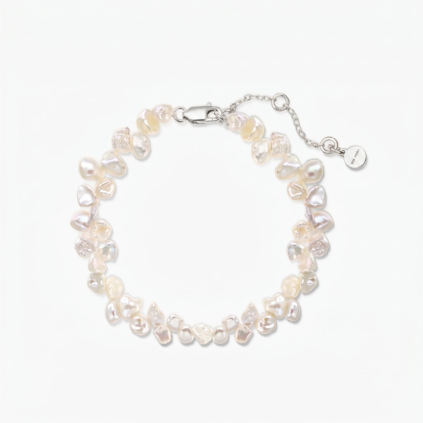 Elegant adjustable keshi freshwater pearl bracelet with a rhodium-plated 925 silver lobster clasp and extender chain on a white background.
