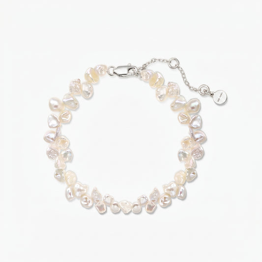 Elegant adjustable keshi freshwater pearl bracelet with a rhodium-plated 925 silver lobster clasp and extender chain on a white background.
