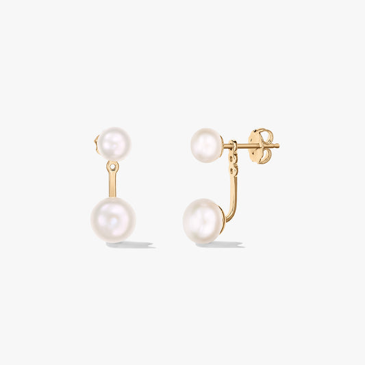 Pair of gold‑plated sterling silver ear‑jacket stud earrings with natural white pearls shown on a white background—one front view and one side view with butterfly back.