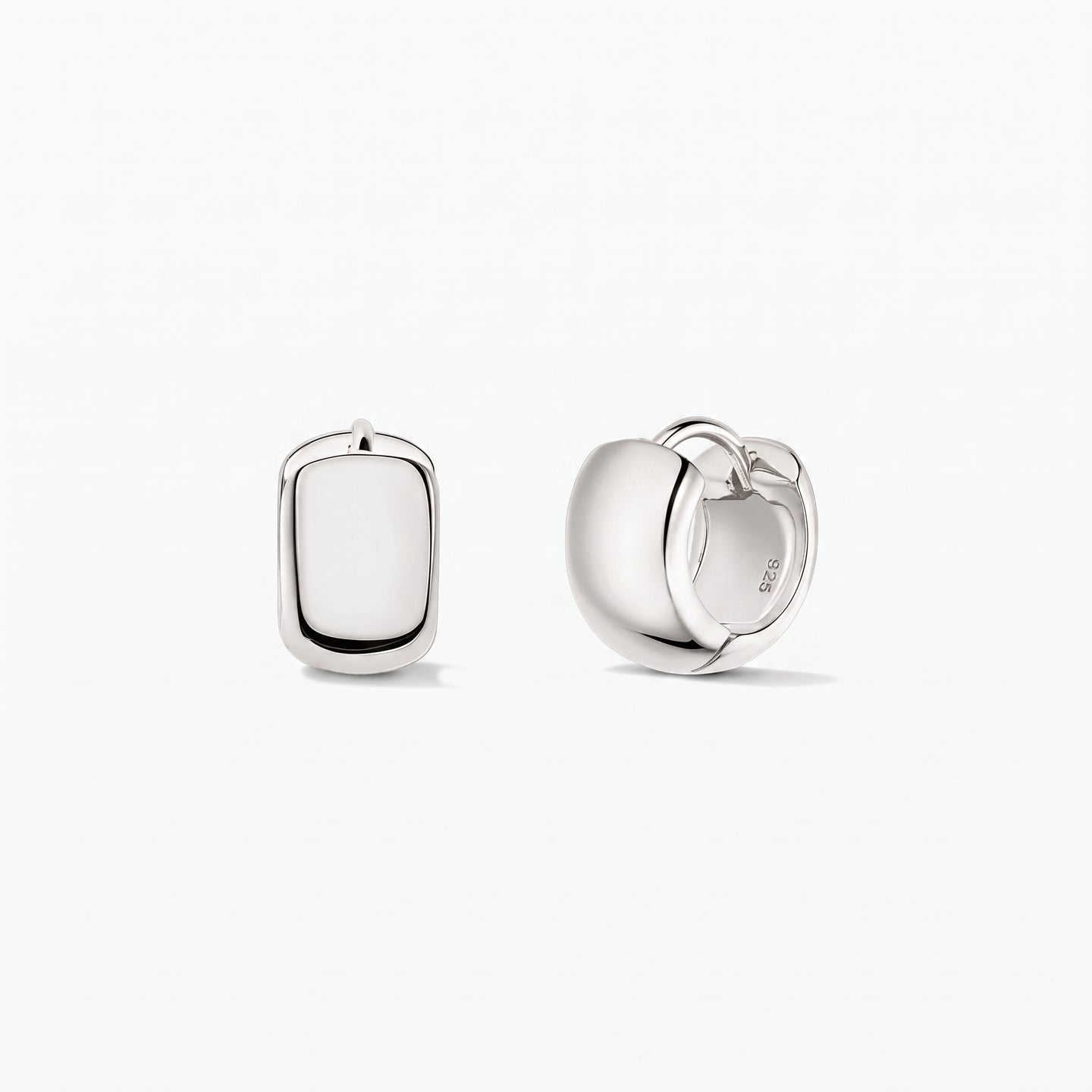 Bold Mini Hoops Silver Earrings in 925 sterling silver by Indira, shown on a white background—one earring front-facing and the other in side view showing the hinged clasp.