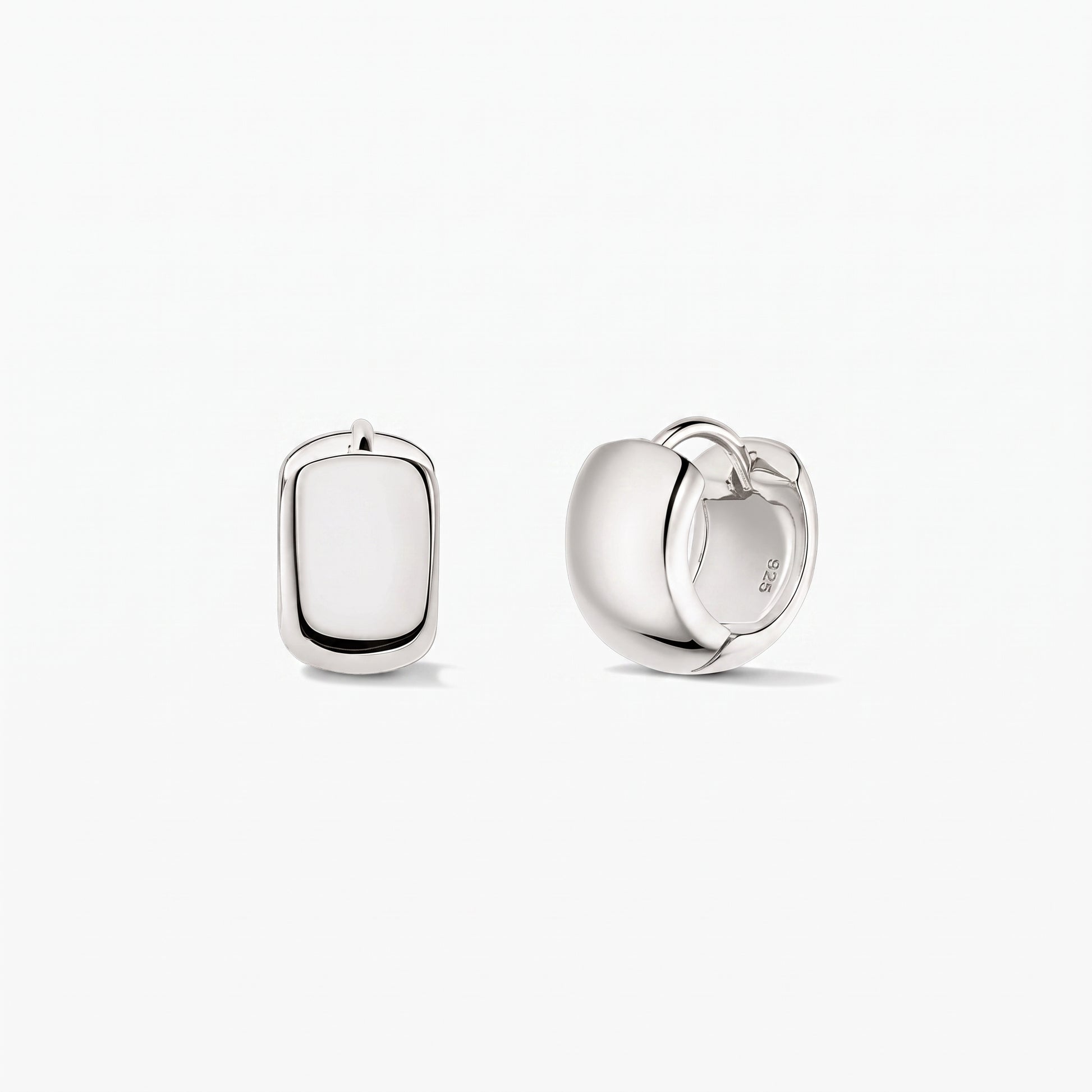 Bold Mini Hoops Silver Earrings in 925 sterling silver by Indira, shown on a white background—one earring front-facing and the other in side view showing the hinged clasp.