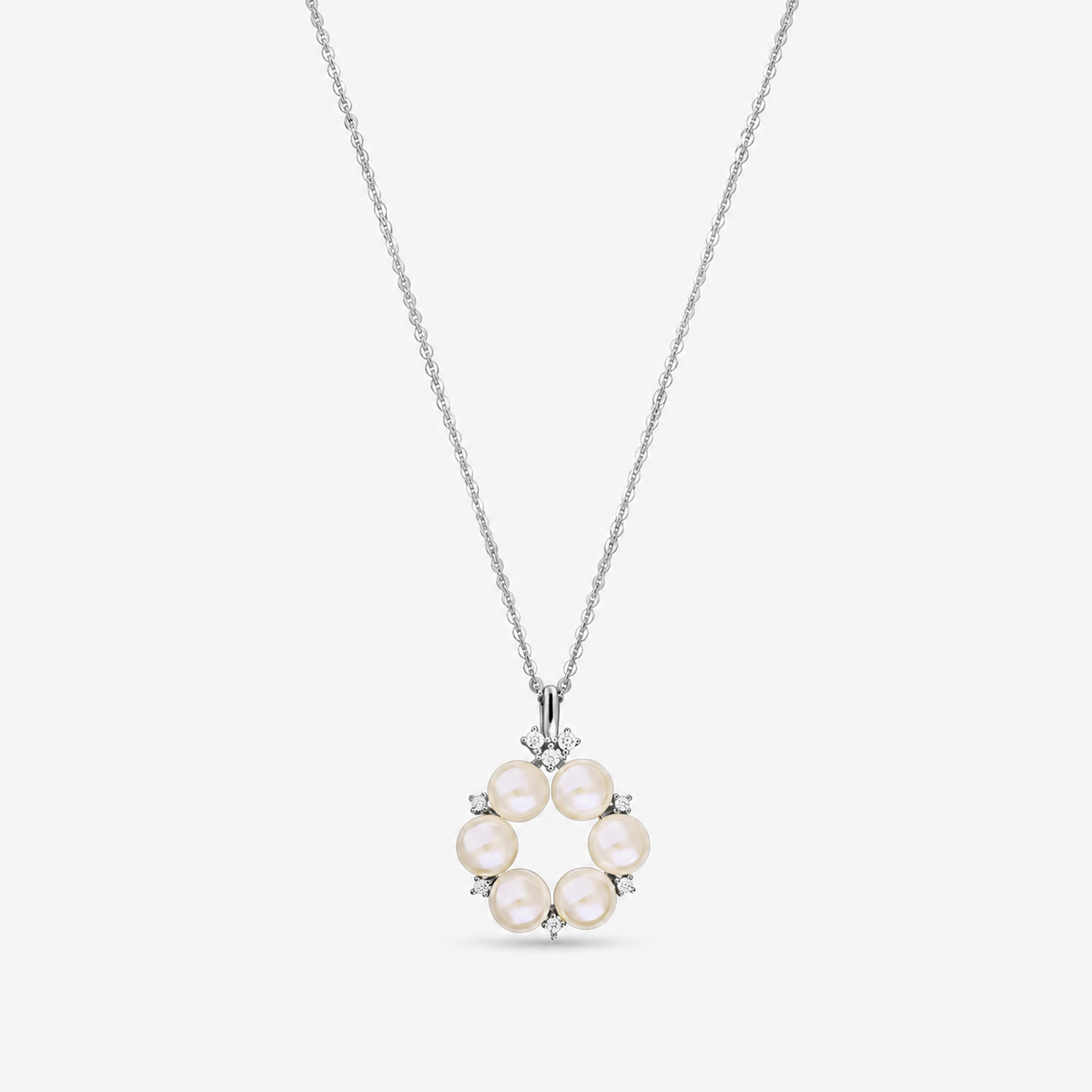 Sterling silver necklace with a circular pendant of six natural pearls accented by small white zirconia, shown on a fine chain against a white background.
