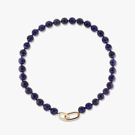 Golden Mareille silver necklace featuring round lapis lazuli beads and a gold-tone link clasp on a white background.