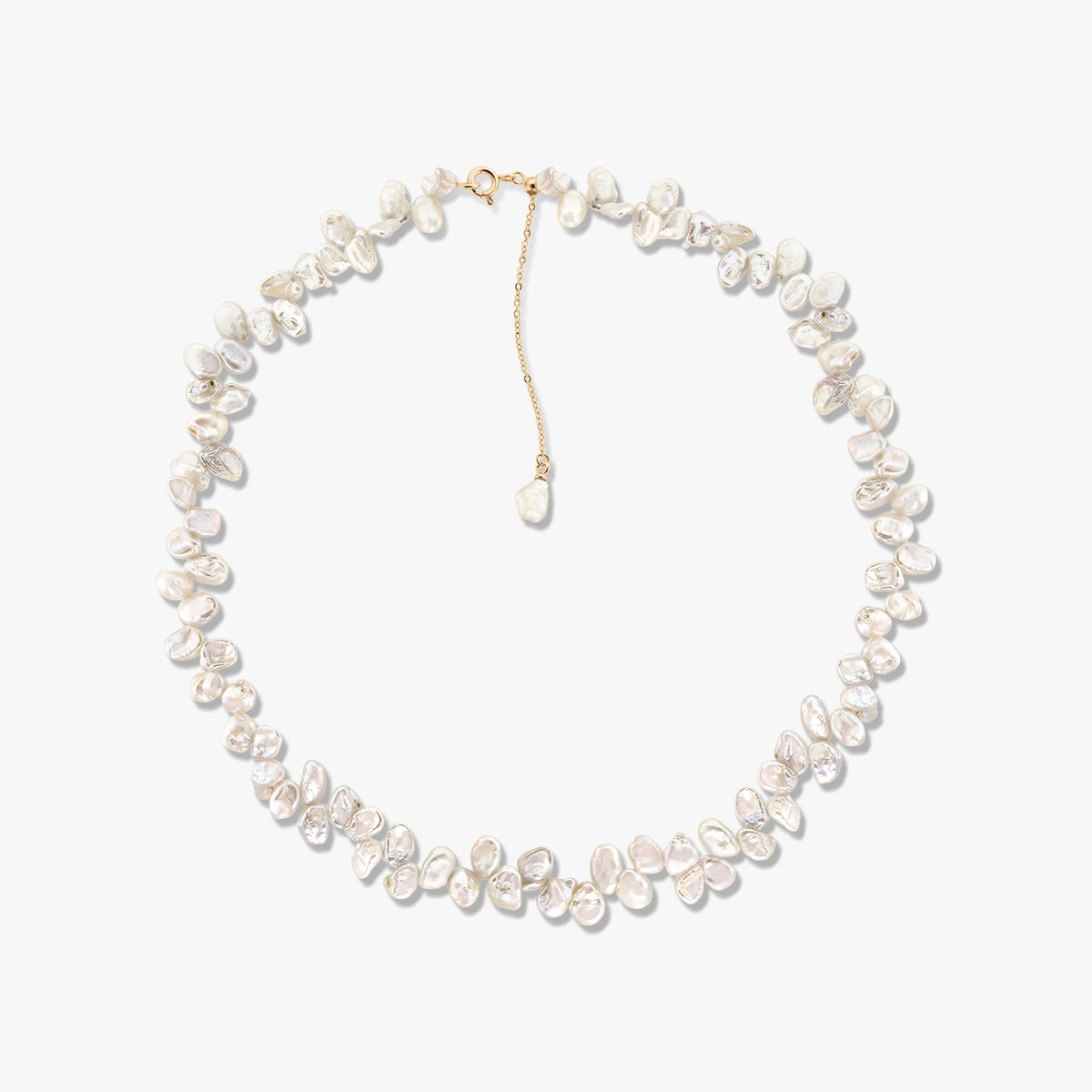 Golden Brielle cultured pearl necklace featuring irregular baroque pearls and a gold-tone chain extender against a white background.