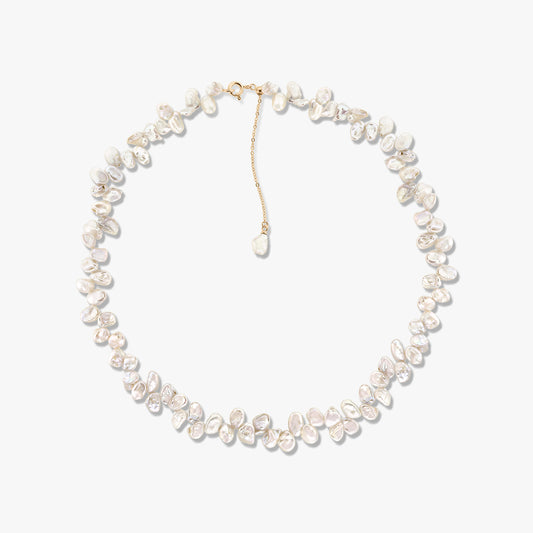 Golden Brielle cultured pearl necklace featuring irregular baroque pearls and a gold-tone chain extender against a white background.