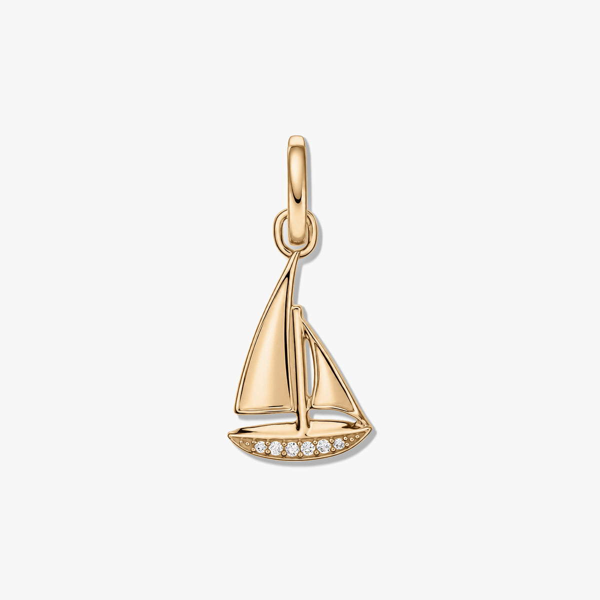 Golden-finish sterling silver sailboat pendant with pavé zirconia along the hull, isolated on a white background.
