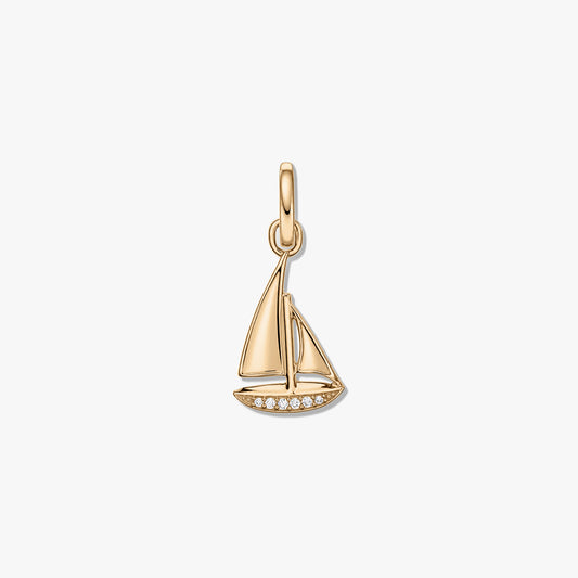 Sterling silver sailboat-shaped pendant with gold-tone finish and clear zirconia accents on a white background.